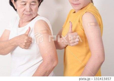 Adult and Elderly Woman with bandage after received vaccine. Vaccination and Immunization for Influenza, HPV, Zoster, IPD, DTP, Dengue, Encephalitis, Rabies, Pneumococcal Hepatitis B and Covid vaccine 131413857