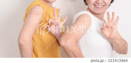 Adult and Elderly Woman with bandage after received vaccine. Vaccination and Immunization for Influenza, HPV, Zoster, IPD, DTP, Dengue, Encephalitis, Rabies, Pneumococcal Hepatitis B and Covid vaccine Adult and Elderly Woman with bandage after received vaccine. Vaccination and Immunization for Influenza, HPV, Zoster, IPD, DTP, Dengue, Encephalitis, Rabies, Pneumococcal Hepatitis B and Covid vaccine 131413864
