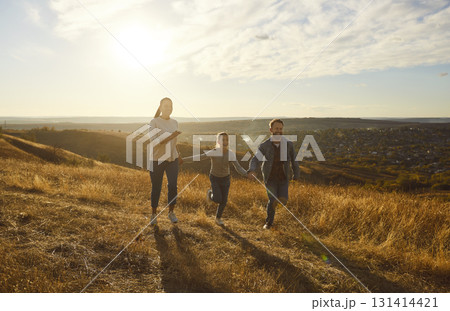 Portrait of happy smiling family with daughter walking outdoors enjoying beautiful nature Portrait of happy smiling family with daughter walking outdoors enjoying beautiful nature 131414421
