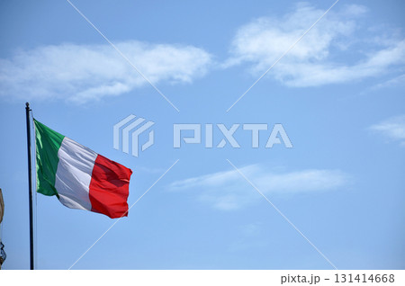 Waving flag of Italy against blue sky 131414668