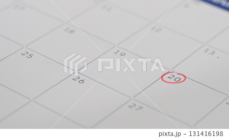 Close up of a calendar page with the 20th day circled in red, representing an important appointment Close up of a calendar page with the 20th day circled in red, representing an important appointment 131416198