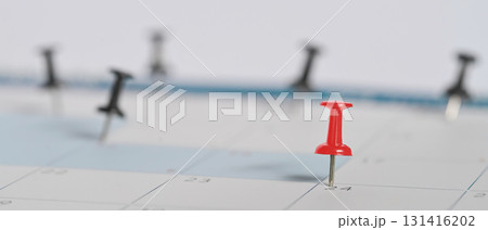 Calendar with a red push pin marking an important date, symbolizing appointment reminders 131416202