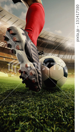 Soccer shoe in red socks pressing ball on vibrant 3D stadium grass with determination 131417380