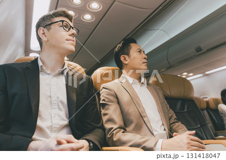 businessman mix race in flight on board cabin row together. businessman mix race in flight on board cabin row together. 131418047