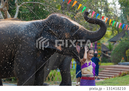 Songkran festival. Northern Thai people in Traditional clothes dressing splashing water together in Songkran day cultural festival with elephant. Songkran festival. Northern Thai people in Traditional clothes dressing splashing water together in Songkran day cultural festival with elephant. 131418210