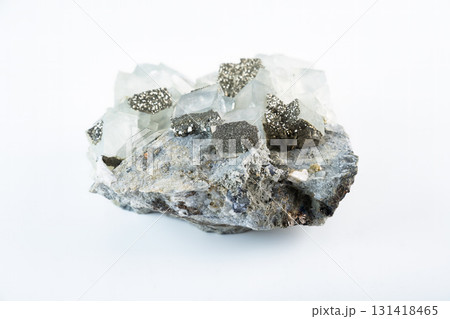Fluorite mineral stone with cubic crystals and pyrite inclusions, a natural calcium fluoride specimen displayed on a white background. 131418465