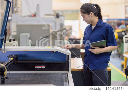 Asian women worker work in heavy industry with CNC lathe milling metal machine in steel product factory Asian women worker work in heavy industry with CNC lathe milling metal machine in steel product factory 131418654