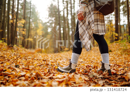 Woman's legs in boots in autumn foliage. Leaf fall. Lifestyle concept. Woman's legs in boots in autumn foliage. Leaf fall. Lifestyle concept. 131418724
