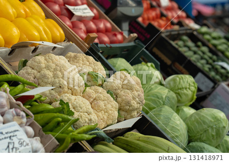 Fresh cauliflower for sale. Cauliflower at a vegetable stand at a farmers' market, or in the produce section of a supermarket or grocery store. Fresh cauliflower for sale. Cauliflower at a vegetable stand at a farmers' market, or in the produce section of a supermarket or grocery store. 131418971