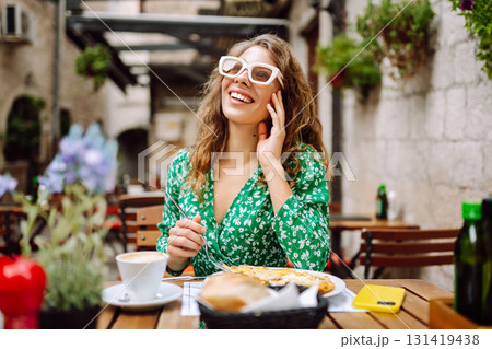 Young Woman eating Italian pasta at restaurant on the street in Rome. Gastronomy and travel 131419438