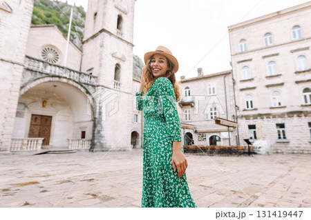 Happy female tourist in beautiful dress walking in the street of the city. Fashion style. Travel. 131419447