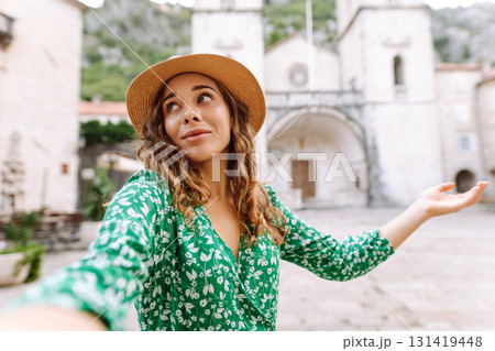 Beautiful woman walks the streets and takes selfie using smartphone camera. Blogging, lifestyle Beautiful woman walks the streets and takes selfie using smartphone camera. Blogging, lifestyle 131419448