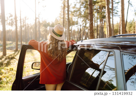 Stopping during a car trip. Young woman enjoying nature. Journey by car. Lifestyle, travel, tourism 131419932