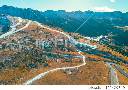 Mountain landscape on a sunny autumn day. View of highway in Pyrenees mountains, Andorra, Europe Mountain landscape on a sunny autumn day. View of highway in Pyrenees mountains, Andorra, Europe 131420749