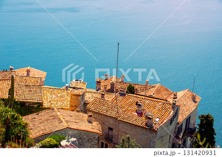 The medieval village of Eze in France. Ancient houses with tiled roofs against the backdrop of the sea 131420931