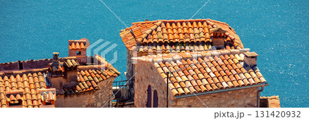 The medieval village of Eze in France. Ancient houses with tiled roofs against the backdrop of the sea The medieval village of Eze in France. Ancient houses with tiled roofs against the backdrop of the sea 131420932