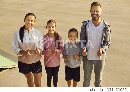 Happy smiling sporty family with children looking cheerful at camera after workout in nature. 131421025