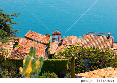 The medieval village of Eze in France. Ancient houses with tiled roofs against the backdrop of the sea The medieval village of Eze in France. Ancient houses with tiled roofs against the backdrop of the sea 131421034