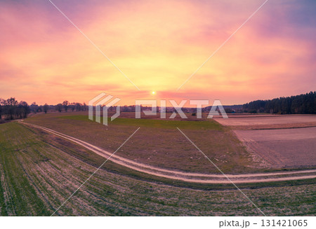 Rural landscape during sunset. View from above of plowed fields and country dirt road. Nature landscape. Nature background 131421065