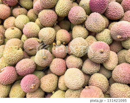 heap of Fresh Lychee Fruits with Rough Pink-Green Skin in Natural Light on market. heap of Fresh Lychee Fruits with Rough Pink-Green Skin in Natural Light on market. 131421095