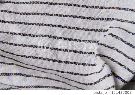 Plaid material. Towel on the table. Wrinkled fabric with stripes. 131423008