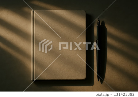 Minimalistic notebook and pen with soft natural light and shadows, perfect for writing, planning, or creative work. Minimalistic notebook and pen with soft natural light and shadows, perfect for writing, planning, or creative work. 131423382