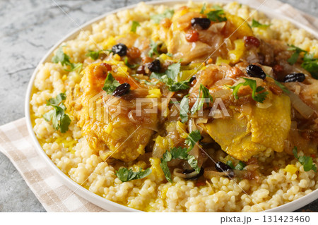 Moroccan Couscous Tfaya Sweet and Savoury Couscous with braised Chicken closeup on the plate. Horizontal Moroccan Couscous Tfaya Sweet and Savoury Couscous with braised Chicken closeup on the plate. Horizontal 131423460