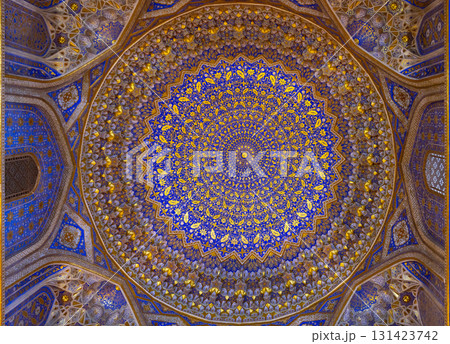 Geometrical designs in azure and gold adorn an arched ceiling. Samarkand 131423742
