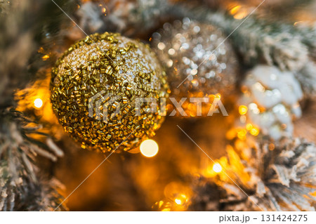 Merry Christmas Xmas happy holidays. Golden silver ornament decoration ball, defocused garland lights on classic decorated Christmas tree. Christmas tree with frosty ornaments. Christmas eve at home 131424275