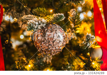 Merry Christmas Xmas happy holidays. Golden ornament decoration ball and defocused garland lights on classic decorated Christmas tree. Christmas tree with red white ornaments. Christmas eve at home 131424289