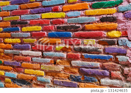Brightly painted brick wall in Kampung Warna Warni, Malang, Java, Indonesia. Creative urban detail from colorful village. Backgrounds, travel promotion, or concepts of diversity, vibrance, and art Brightly painted brick wall in Kampung Warna Warni, Malang, Java, Indonesia. Creative urban detail from colorful village. Backgrounds, travel promotion, or concepts of diversity, vibrance, and art 131424635
