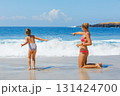 Mother, daughter playing together on beach, enjoying waves and warm summer day. Family vacation fun by ocean with kids. White sand, turquoise sea. Travel lifestyle, summer holiday, beach destinations 131424700