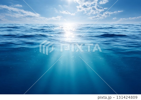 Ocean surface glimmers in sunlight, with beams of light cutting through water. Great for sea and relaxation themes. 131424809
