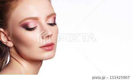 Close-up of Beautiful Model Woman with Fashion Make-up on white backdrop with copy space. Prom or Bride Girl Style. Perfect for Beauty salon, Cosmetic Advertising or Makeup Artist Close-up of Beautiful Model Woman with Fashion Make-up on white backdrop with copy space. Prom or Bride Girl Style. Perfect for Beauty salon, Cosmetic Advertising or Makeup Artist 131425907