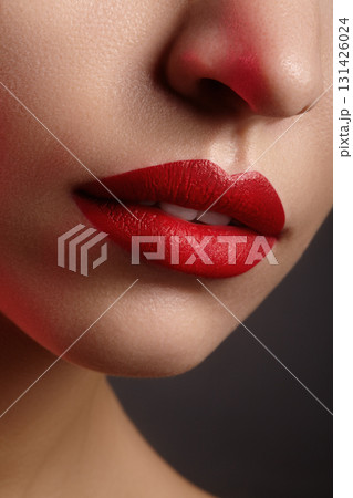 Beauty closeup of woman lips with dark red lipstick, smooth skin and elegant facial contour. Great for fashion, cosmetics, lifestyle and sensual advertising themes Beauty closeup of woman lips with dark red lipstick, smooth skin and elegant facial contour. Great for fashion, cosmetics, lifestyle and sensual advertising themes 131426024