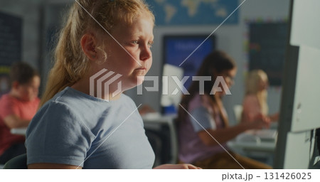 Focused Schoolgirl Using Computer in Modern Classroom Focused Schoolgirl Using Computer in Modern Classroom 131426025