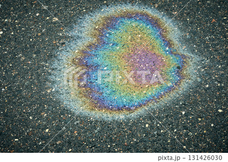 Iridescent gasoline puddle creating a colorful abstract texture on wet asphalt Iridescent gasoline puddle creating a colorful abstract texture on wet asphalt 131426030