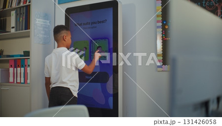 Young Boy Takes Personality Temperament Test on AI Mood Tracker Digital Screen 131426058