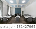 Interior of a meeting room with empty tables and chairs. 131427965