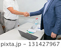 Handshake of businessmen against the background of a negotiating table. Conclusion of a deal. 131427967