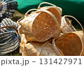 Wicker baskets at a craft fair. There are many of them, all piled up. 131427971