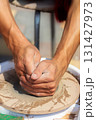 Close-up of the calloused hands of a master potter at work. 131427973