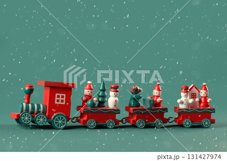 Christmas toy wooden red retro train decorated with children's snowmen and Christmas trees. Vintage naive postcard on an emerald background with snow.. Christmas toy wooden red retro train decorated with children's snowmen and Christmas trees. Vintage naive postcard on an emerald background with snow.. 131427974
