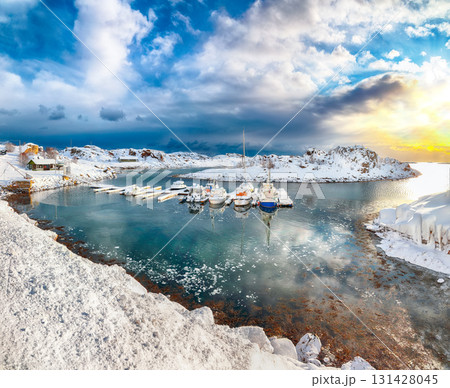 Amazing winter scenery with yachts and boats nier pier in small fishing village and snowy mountain peaks near Valberg Amazing winter scenery with yachts and boats nier pier in small fishing village and snowy mountain peaks near Valberg 131428045