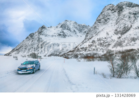 Dramatic snowy winter scene of Vestvagoy island with snowy mountain peaks on Lofoten Islands . Dramatic snowy winter scene of Vestvagoy island with snowy mountain peaks on Lofoten Islands . 131428069