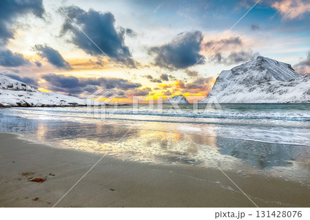 Amazing winter view of Vik beach during sunset with lots of snow  and snowy  mountain peaks near Leknes. 131428076