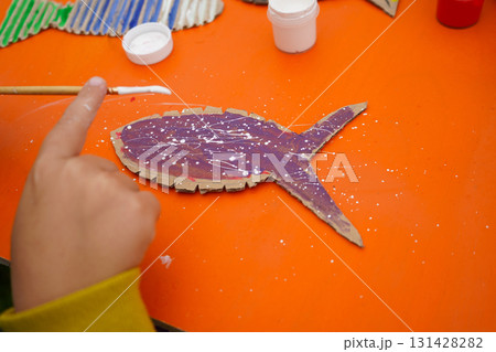 Create a fish model from cardboard, thread, and paint, with step-by-step guidance, on an orange backdrop. Create a fish model from cardboard, thread, and paint, with step-by-step guidance, on an orange backdrop. 131428282