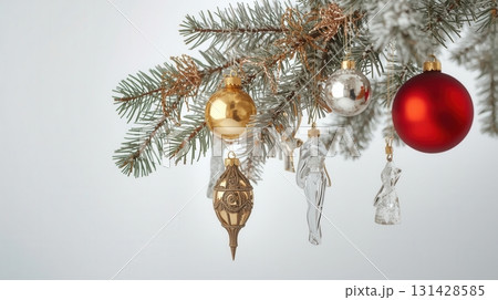 Festive Christmas ornaments hanging on pine tree branch with red, gold, and glass decorations 131428585
