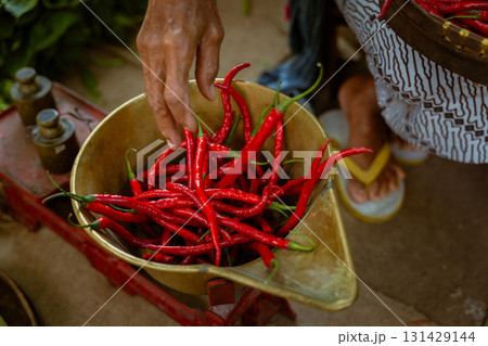 A colorful array of Fresh Red Chilies beautifully arranged in a Market Basket for sale A colorful array of Fresh Red Chilies beautifully arranged in a Market Basket for sale 131429144