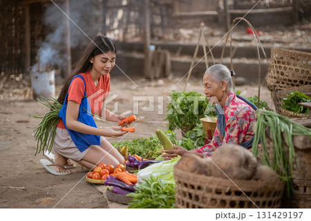 Women actively participate in cultural activities at local vegetable markets, enhancing community Women actively participate in cultural activities at local vegetable markets, enhancing community 131429197